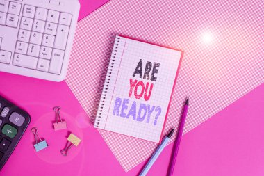 Text sign showing Are You Ready Question. Conceptual photo Setting oneself on the activity Being Prepared Writing equipments and computer stuffs placed above colored plain table.