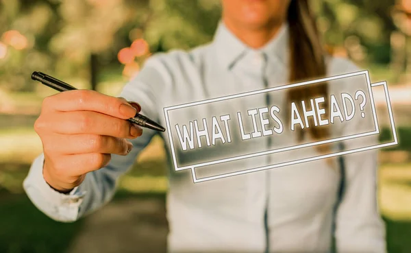 Word writing text What Lies Ahead Question. Business concept for Asking for information about something on the way Woman in a blue business shirts pointing with her finger into empty space. — ストック写真