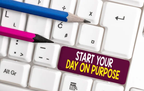 Conceptual hand writing showing Start Your Day On Purpose. Business photo text Have clean ideas of what you are going to do White pc keyboard with note paper above the white background. — ストック写真