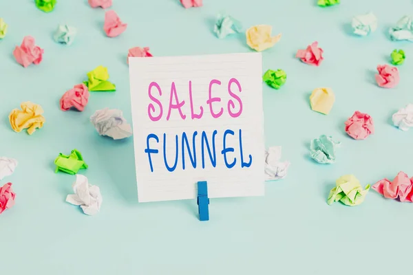 Conceptual hand writing showing Sales Funnel. Business photo showcasing process through which a company ells its products to buyers Colored crumpled papers empty reminder blue floor clothespin. — ストック写真