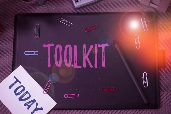 Conceptual hand writing showing Toolkit. Business photo showcasing set of tools kept in a bag or box and used for a particular purpose Scissors and equipments math book above textured backdrop. — 스톡 사진