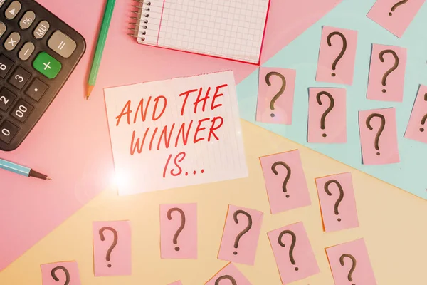 Word writing text And The Winner Is. Business concept for announcing a demonstrating or thing that wins something Mathematics stuff and writing equipment above pastel colours background. — Stock Photo, Image