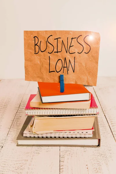 Writing note showing Business Loan. Business photo showcasing Credit Mortgage Financial Assistance Cash Advances Debt pile stacked books notebook pin color reminder white wooden.