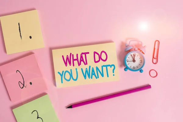 Writing note showing What Do You Want Question. Business photo showcasing Tell me your desires requests deanalysisds ambition Blank notepads marker rubber band alarm clock clip colored background. — 스톡 사진