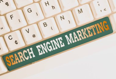 Text sign showing Search Engine Marketing. Conceptual photo promote Website visibility on searched result pages White pc keyboard with empty note paper above white background key copy space.