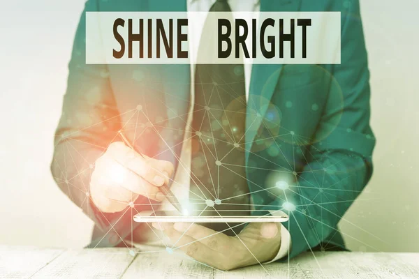 Text sign showing Shine Bright. Conceptual photo make an effort to live normally when in a difficult situation Male human wear formal work suit presenting presentation using smart device. — 图库照片