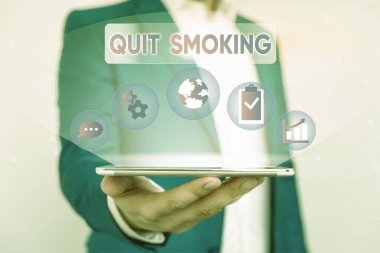 Writing note showing Quit Smoking. Business photo showcasing process of discontinuing tobacco smoking or cessation Male human wear formal suit presenting using smart device.