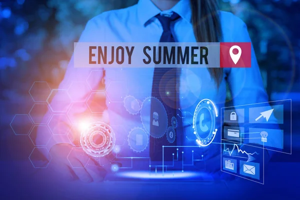 Handwriting text Enjoy Summer. Concept meaning taking a break from school and spending holidays in the beach Woman wear formal work suit presenting presentation using smart device. — Stok fotoğraf