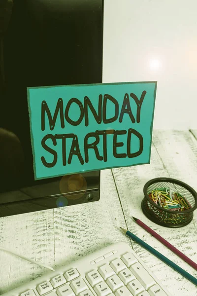 Conceptual hand writing showing Monday Started. Business photo text getting ready for new week Rest is over lets begin work Note paper taped to black screen near keyboard stationary. — Stock Photo, Image