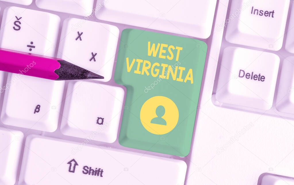 Writing note showing West Virginia. Business photo showcasing United States of America State Travel Tourism Trip Historical White pc keyboard with note paper above the white background.