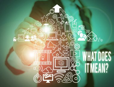 Writing note showing What Does It Mean Question. Business photo showcasing Give me the meaning of something Definition Woman wear formal work suit presenting presentation using smart device.