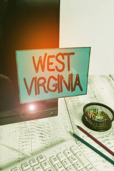 Conceptual hand writing showing West Virginia. Business photo text United States of America State Travel Tourism Trip Historical Note paper taped to black screen near keyboard stationary. — 图库照片