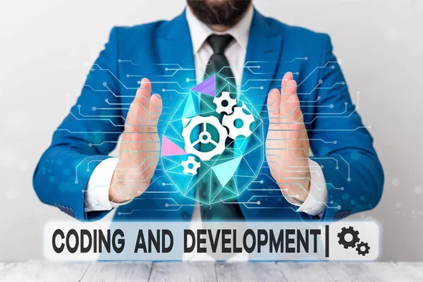 Text sign showing Coding And Development. Conceptual photo Programming Building simple assembly Programs Male human wear formal work suit presenting presentation using smart device. — Stockfoto