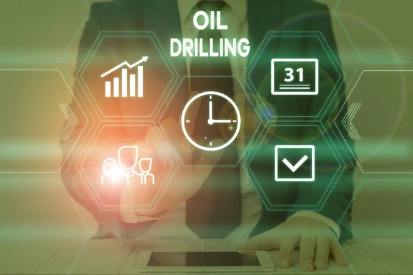 Text sign showing Oil Drilling. Conceptual photo involves the drilling and pumping of oil from underground wells Male human wear formal work suit presenting presentation using smart device. — ストック写真