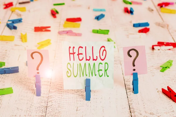Conceptual hand writing showing Hello Summer. Business photo showcasing season after spring and before autumn where the weather is hot Crumbling sheet with paper clips placed on the wooden table. — Stock Photo, Image