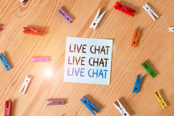 Writing note showing Live Chat Live Chat Live Chat. Business photo showcasing talking with showing friends relatives online Colored clothespin papers empty reminder wooden floor background office.