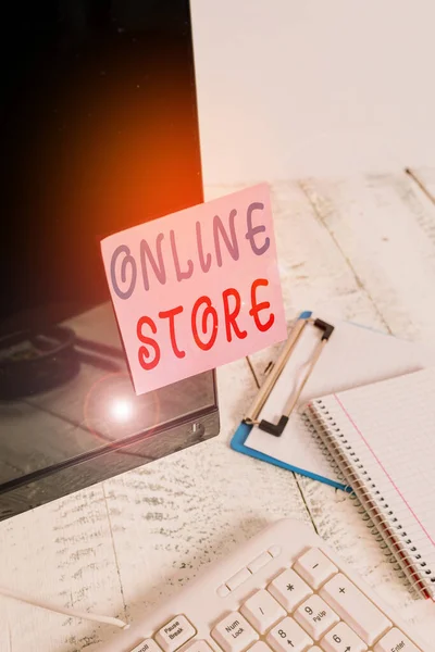 Writing note showing Online Store. Business photo showcasing A website that offers items for sale and accepts credit cards Note paper taped to black computer screen near keyboard and stationary. — Stock Photo, Image