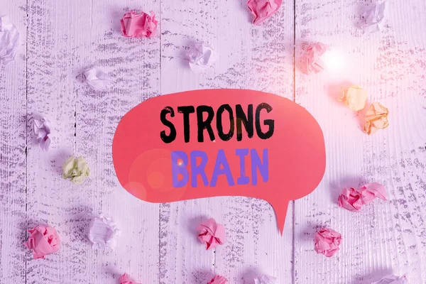 Conceptual hand writing showing Strong Brain. Business photo text own firm attitudes and opinions and are not easily influenced Colored speech bubble paper balls wooden rustic vintage background.