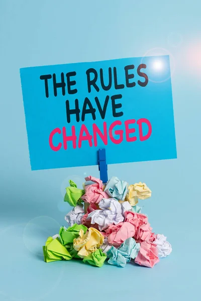 Text sign showing The Rules Have Changed. Conceptual photo the agreement or Policy has a new set of comanalysisds Reminder pile colored crumpled paper clothespin reminder blue background. — Stock Photo, Image