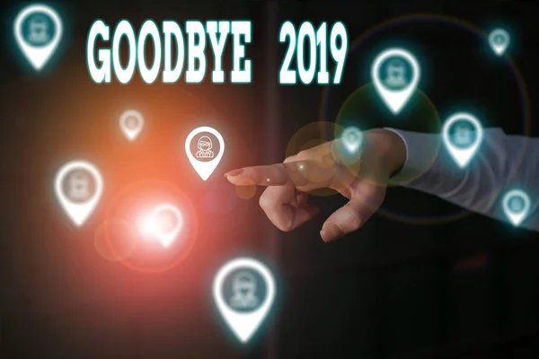 Writing note showing Goodbye 2019. Business photo showcasing expressing good wishes during parting at the end of the year Woman wear formal work suit presenting presentation using smart device.