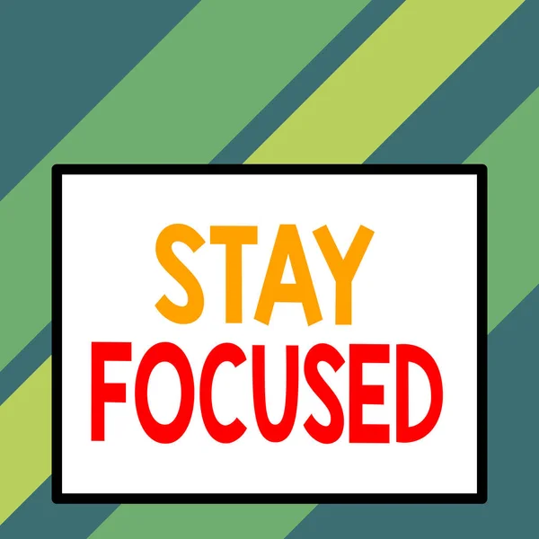 Text sign showing Stay Focused. Conceptual photo direct time and attention to a limited number of issues Front close up view big blank rectangle abstract geometrical background.