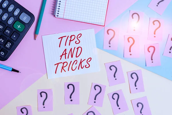 Word writing text Tips And Tricks. Business concept for piece of inside facts specially in betting or investing Mathematics stuff and writing equipment above pastel colours background.