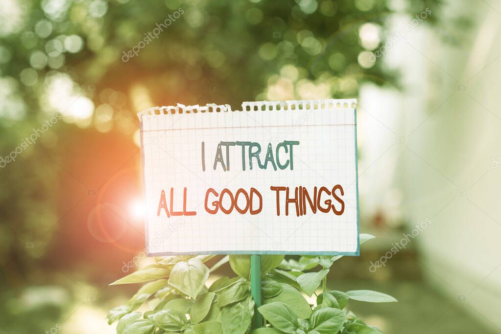 Word writing text I Attract All Good Things. Business concept for Positive attraction law Motivation Affirmation Plain empty paper attached to a stick and placed in the green leafy plants.