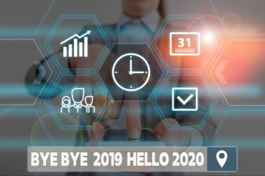 Conceptual hand writing showing Bye Bye 2019 Hello 2020. Business photo showcasing Starting new year Motivational message 2019 is over Woman wear work suit presenting presentation smart device.
