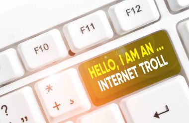 Writing note showing Hello I Am An Internet Troll. Business photo showcasing Social media troubles discussions arguments White pc keyboard with note paper above the white background.