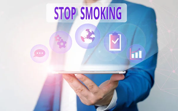 Handwriting text writing Stop Smoking. Concept meaning the process of discontinuing or quitting tobacco smoking Male human wear formal work suit presenting presentation using smart device. — Stock Photo, Image