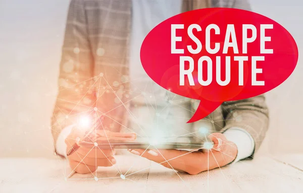 Writing note showing Escape Route. Business photo showcasing a route by which a demonstrating may reach a place of safety Female human wear formal work suit presenting smart device. — Stockfoto