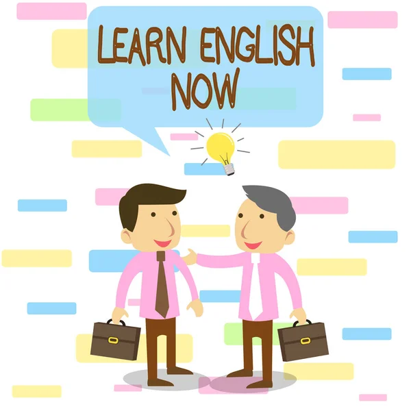 Writing note showing Learn English Now. Business photo showcasing gain or acquire knowledge and skill of english language Two White Businessmen Colleagues with Brief Cases Sharing Idea Solution. — Stockfoto