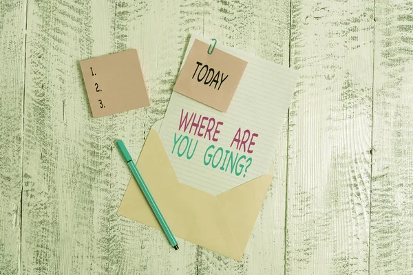 Conceptual hand writing showing Where Are You Going Question. Business photo text asking someone where he is heading to Envelope blank sheet sticky note ballpoint wooden background.