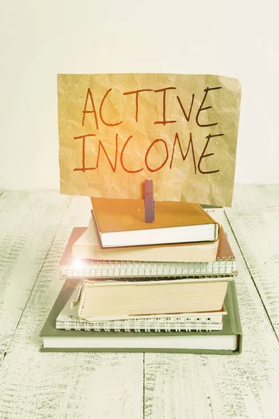 Writing note showing Active Income. Business photo showcasing Royalties Salaries Pensions Financial Investments Tips pile stacked books notebook pin color reminder white wooden. — Stockfoto