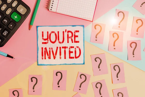 Writing note showing You Re Invited. Business photo showcasing Please join us in our celebration Welcome Be a guest Mathematics stuff and writing equipment above pastel colours background.