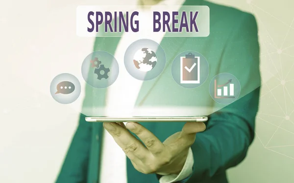 Handwriting text writing Spring Break. Concept meaning week s is vacation for students in the spring typically at Easter Male human wear formal work suit presenting presentation using smart device.