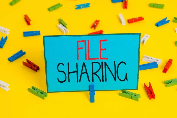 Text sign showing File Sharing. Conceptual photo transmit files from one computer to another over a network Colored clothespin papers empty reminder yellow floor background office. — Stok fotoğraf