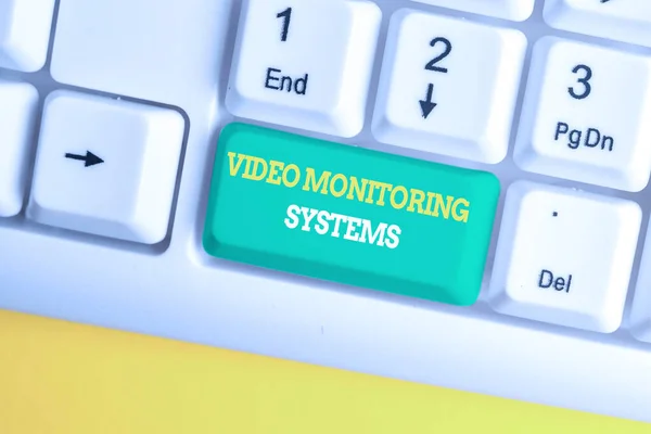 Writing note showing Video Monitoring Systems. Business photo showcasing Surveillance Transmit capture Image to Digital Link White pc keyboard with note paper above the white background. — Stock Photo, Image