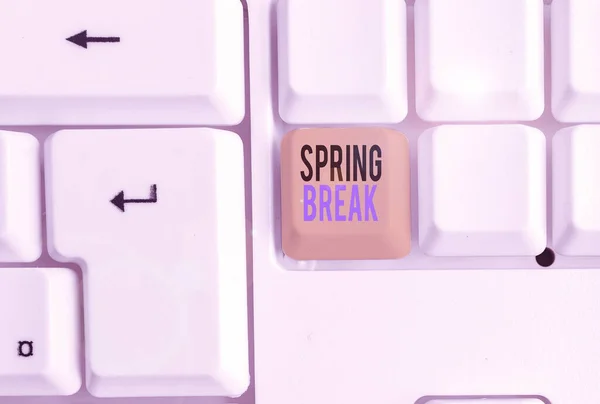 Handwriting text Spring Break. Concept meaning week s is vacation for students in the spring typically at Easter White pc keyboard with empty note paper above white background key copy space. — ストック写真