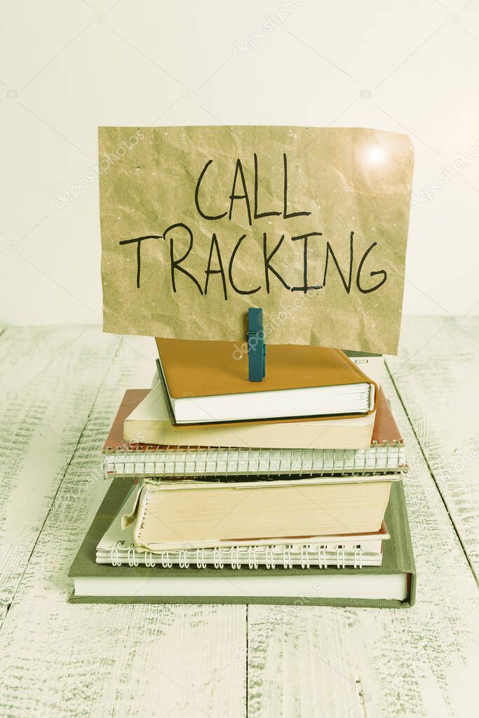 Writing note showing Call Tracking. Business photo showcasing Organic search engine Digital advertising Conversion indicator pile stacked books notebook pin color reminder white wooden.