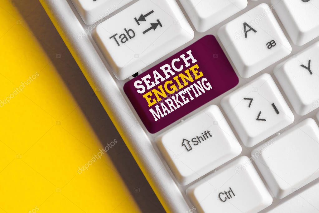 Writing note showing Search Engine Marketing. Business photo showcasing promote Website visibility on searched result pages White pc keyboard with note paper above the white background.