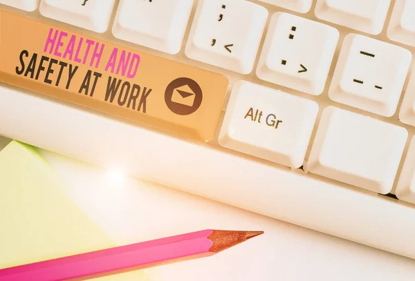 Handwriting text Health And Safety At Work. Concept meaning Secure procedures prevent accidents avoid danger White pc keyboard with empty note paper above white background key copy space.