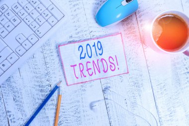 Handwriting text 2019 Trends. Concept meaning general direction in which something is developing or changing technological devices colored reminder paper office supplies keyboard mouse.