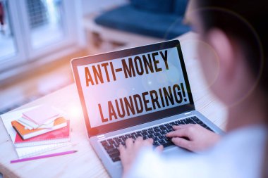 Text sign showing Anti Money Laundering. Conceptual photo regulations stop generating income through illegal actions woman laptop computer office supplies technological devices inside home.