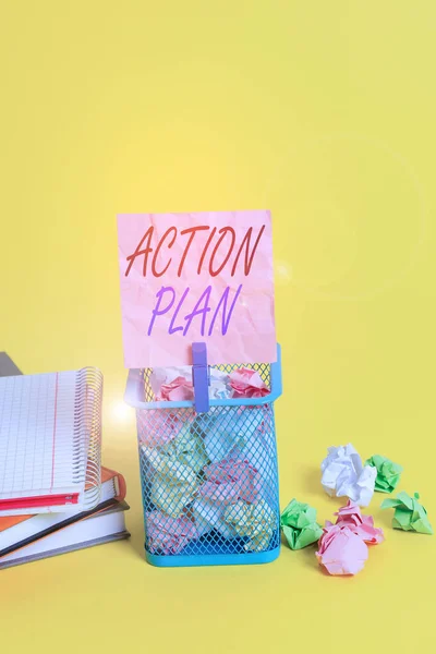Text sign showing Action Plan. Conceptual photo detailed plan outlining actions needed to reach goals or vision Trash bin crumpled paper clothespin empty reminder office supplies yellow.