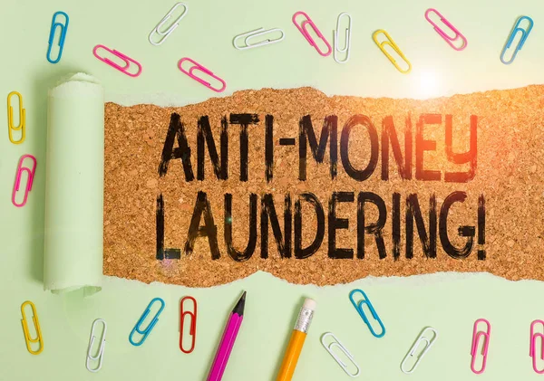 Text sign showing Anti Money Laundering. Conceptual photo regulations stop generating income through illegal actions Stationary and torn cardboard placed above a wooden classic table backdrop.