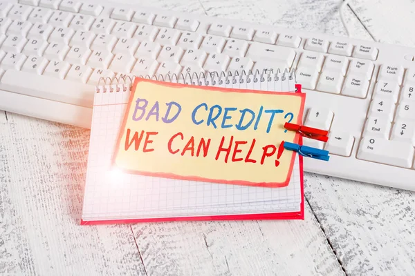 Writing note showing Bad Credit Question We Can Help. Business photo showcasing offering help after going for loan then rejected notebook reminder clothespin with pinned sheet light wooden.