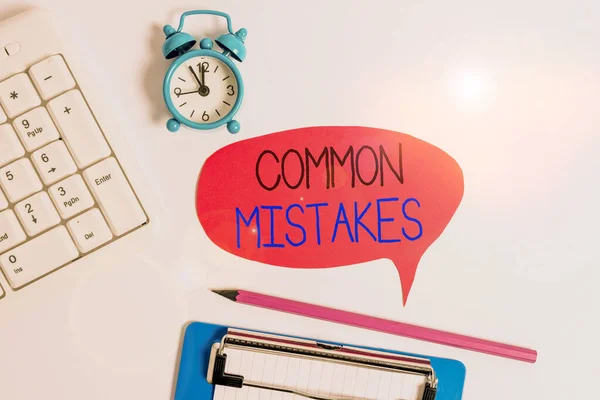 Word writing text Common Mistakes. Business concept for actions that are often used interchangeably with error Flat lay above table with clock pc keyboard and copy space note paper. — Stock Photo, Image