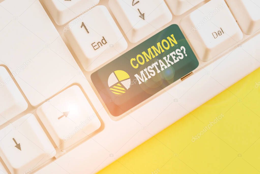 Writing note showing Common Mistakes Question. Business photo showcasing repeat act or judgement misguided making something wrong White pc keyboard with note paper above the white background.