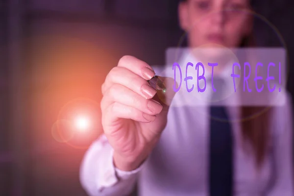 Writing note showing Debt Free. Business photo showcasing does not owning any money or things to any individual or companies Blurred woman in the background pointing with finger in empty space. — Stock Photo, Image